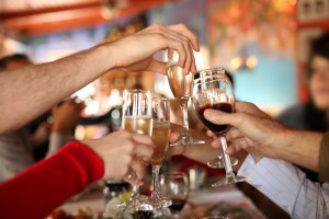 People Toasting With Wine and Champagne: Holiday Hearty Syndrome